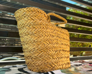 Handcrafted straw bag in natural woven design, perfect for carrying summer essentials with style