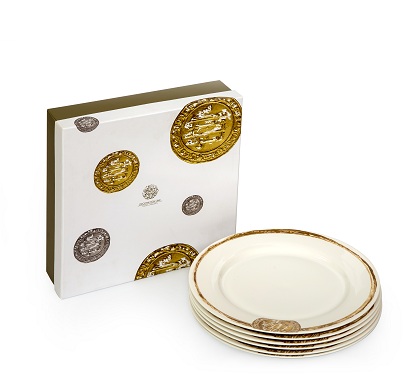alt="Dinner plates with silver and gold coins"